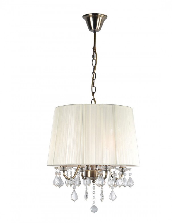 Lámpara color dorado con pantalla de hilo beige.